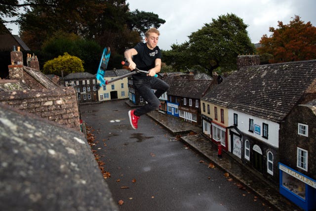 Charlie Sibley, from Wimborne’s StreetLight Project, scooters through the streets of Wimborne Model Town and Gardens in Dorset