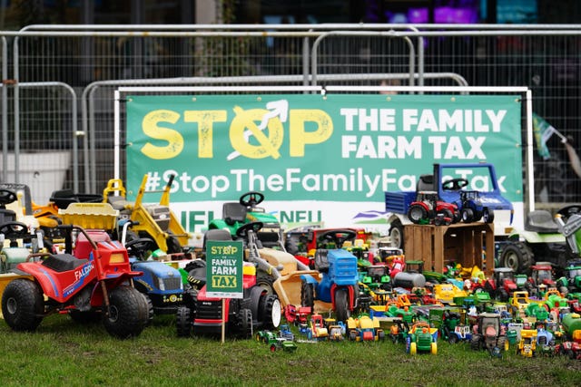 Members of the National Farming Union’s Stop the Family Farm Tax campaign place pre-loved farming toys outside the QEII Centre in London during a protest in February (