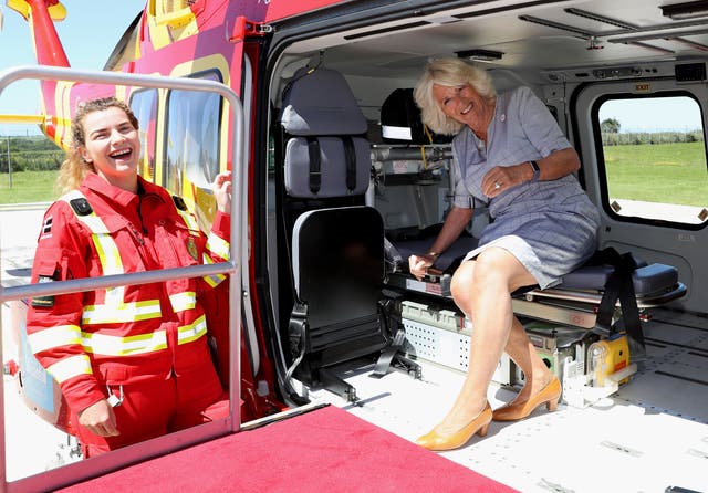 The Duchess of Cornwall speaks with a crew member as she launches the new helicopter. Chris Jackson/PA Wire