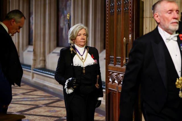 Black Rod Sarah Clarke, stands in the Members’ Lobby at the Palace of Westminster, in her official regalia of black suit and white lace neck piece