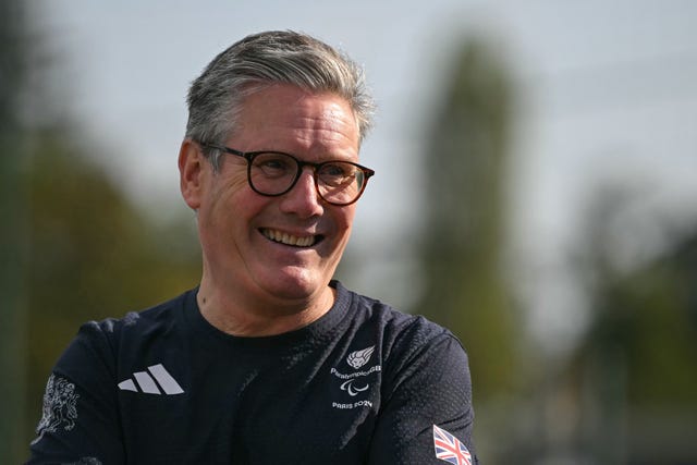 Sir Keir Starmer laughing while wearing a Paralympics GB Paris 2024 T-shirt