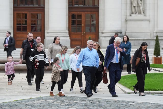 Solicitor Damien Tansey with affected families outside Government Buildings, Dublin