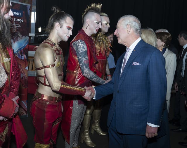 The King and Queen Consort (hidden) speak with the German Eurovision song contest entry Lord of the Lost 