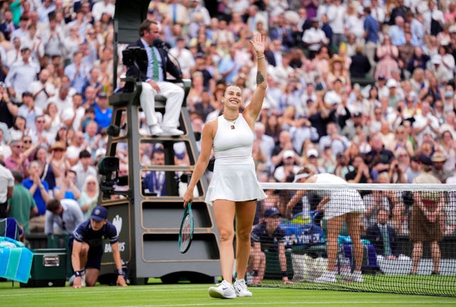 Aryna Sabalenka celebrates by waving at the crowd