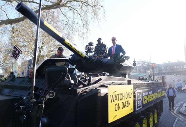 Nigel Farage and Derek Chisora arrive in a tank