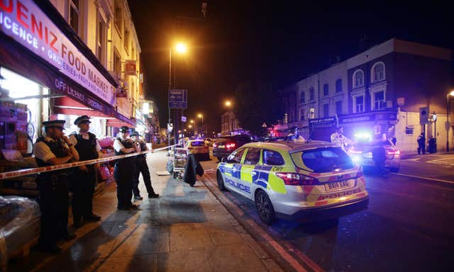 Police at the scene after the attack (PA)