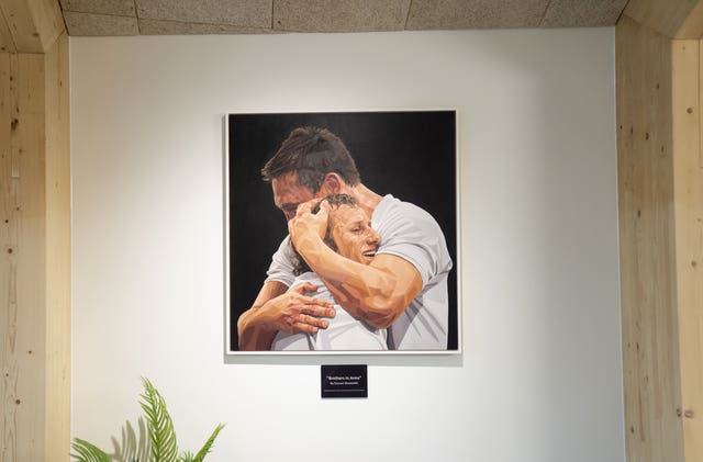 A painting of Rob Burrow being embraced by Kevin Sinfield