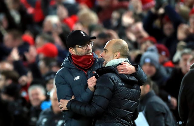 Liverpool took a major step towards a first title in 30 years by beating reigning champions Manchester City 3-1 in November. Jurgen Klopp, left, celebrated victory over Pep Guardiola thanks to goals from Fabinho, Mohamed Salah and Sadio Mane
