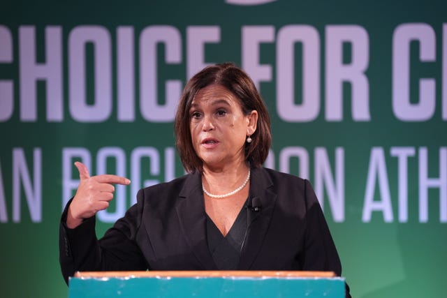 Mary Lou McDonald gesturing with her right hand as she speaks at a lectern