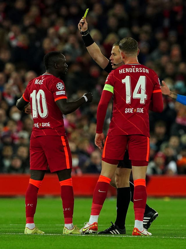Liverpool's Sadio Mane is shown a yellow card 