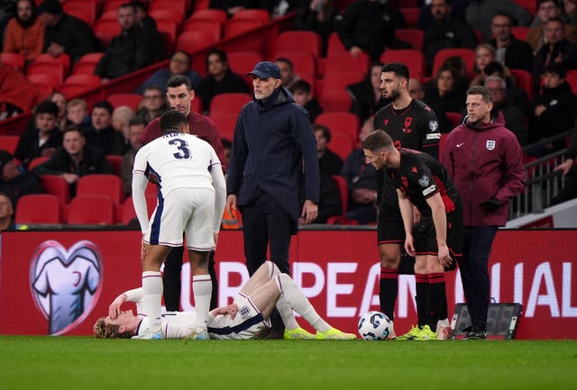 England’s Anthony Gordon lies injured against Albania as Reece James and coach Thomas Tuchel observe