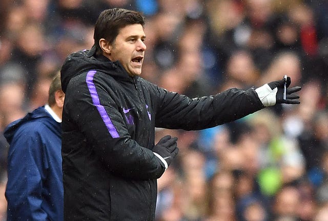 Mauricio Pochettino, wearing gloves, gives his Spurs side some direction