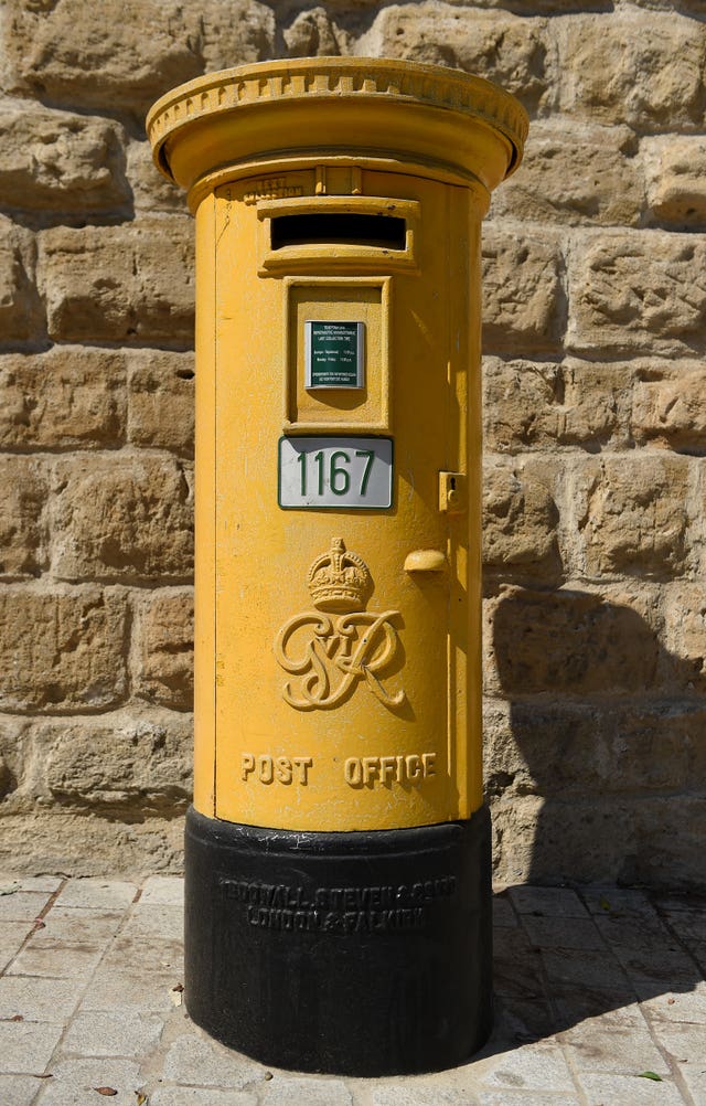 A yellow painted Post Office post box in Nicosia, Cyprus (Andrew Matthews/PA)