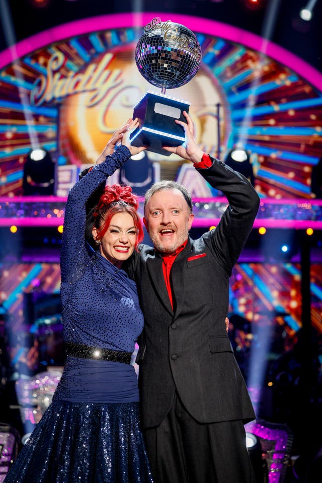 Dianne Buswell and Chris McCausland with the glitterball trophy