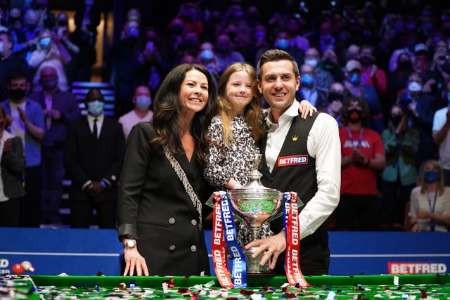 Mark Selby posses with his wife and daughter after winning the world title