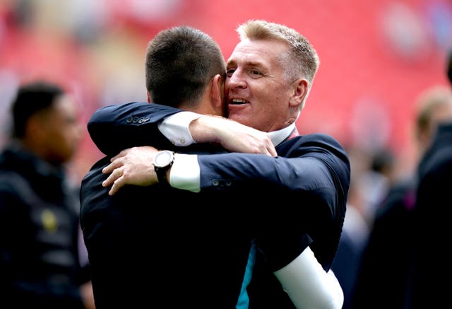 Dean Smith hugs assistant coach John Terry after Villa's play-off final triumph against Derby