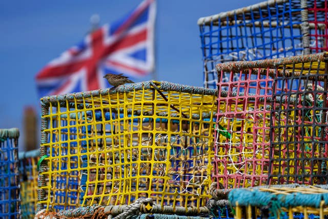 Empty fishing nets sit on the beach at Hastings, Sussex (Steve Parsons/PA)