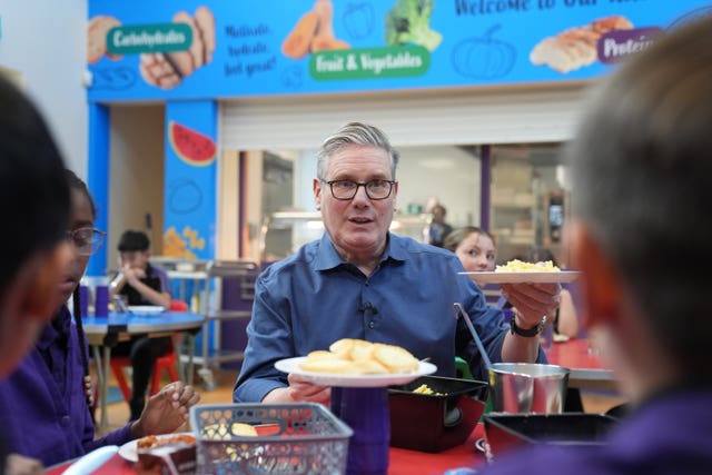 Sir Keir Starmer serving school meals to children