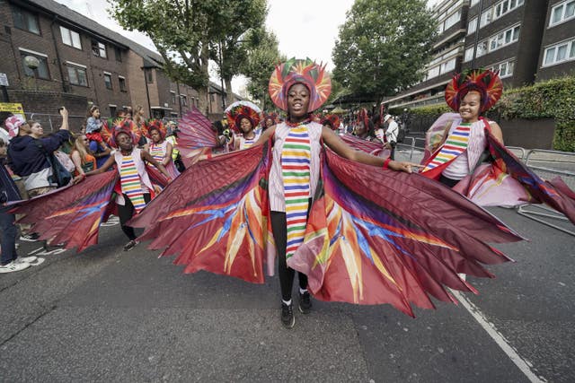 A man in a colourful costume at the Notting Hill Carnival