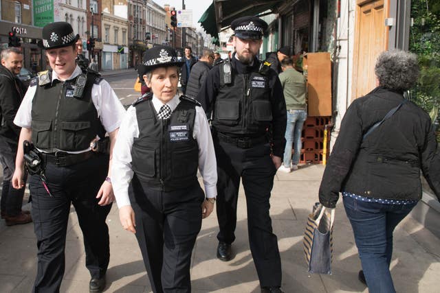 Metropolitan Police Commissioner Cressida Dick (centre) walks with officers through Stoke Newington in north London, after a recent spate of gang violence in which several teenagers died (Stefan Rousseau/PA)