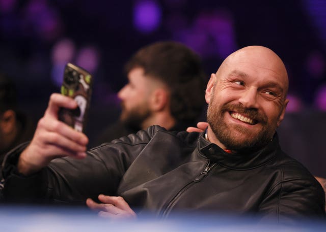 Tyson Fury holds up a phone while ringside at the Co-op Live Arena,