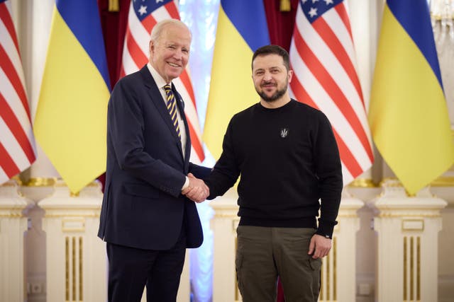 Biden and Zelensky shake hands in front of flags