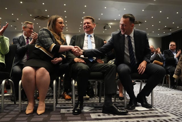 Russell Findlay shakes hands with Meghan Gallacher, with Murdo Fraser between them