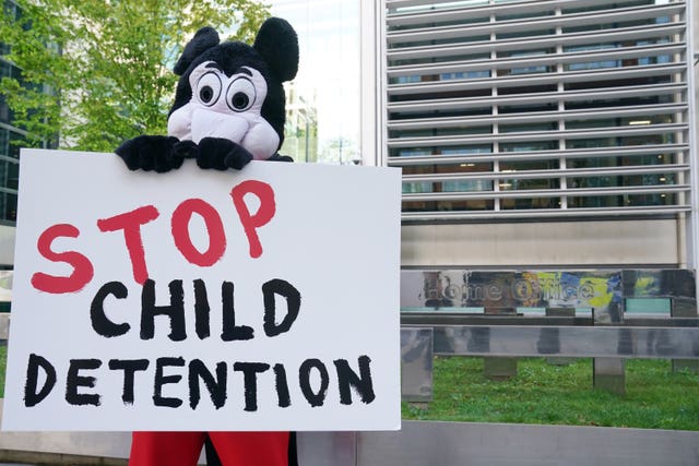 Comedian Dom Joly, dressed as Mickey Mouse, leads a Save the Children protest against the Illegal Migration Bill outside the Home Office in central London