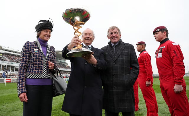 Randox Health Doctor of Medicine Dr Peter FitzGerald (centre right) and Kenny Dalglish (centre right) pose with the 2018 Randox Health Grand National trophy (David Davies/PA)