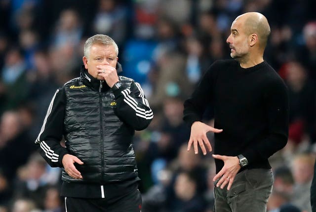 Sheffield United manager Chris Wilder, left, and Manchester City boss Pep Guardiola on the touchline 