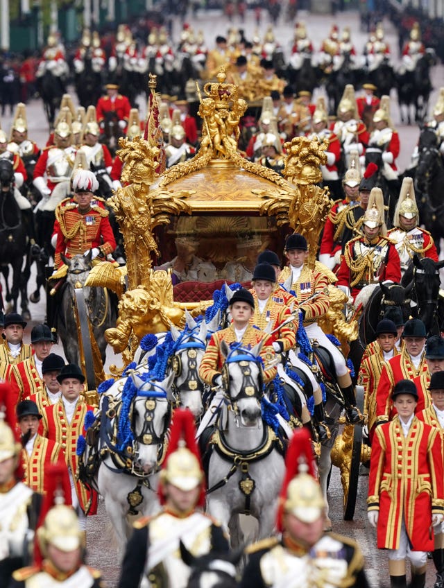 The King and Queen ride in the Gold State Coach after the coronation