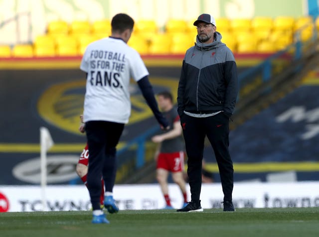 Liverpool manager Jurgen Klopp looks on as Leeds winger Pablo Hernandez warms up wearing a t-shirt opposing the European Super League. The announcement that Arsenal, Chelsea, Liverpool, Manchester City Manchester United and Tottenham would break away from the Premier League to join the new competition was greeted by shock, anger and widespread opposition. The so-called top-six Premier League clubs swiftly withdrew from the ill-fated venture but were left embarrassed and attempting to appease unhappy supporters