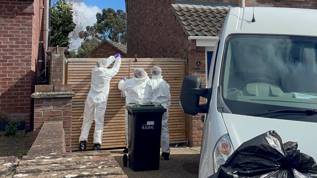 Forensics officers in The Row in Sutton, near Ely, where police found the body of a 57-year-old man