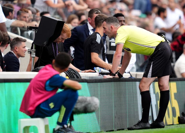 Referee Chris Kavanagh checks VAR screen