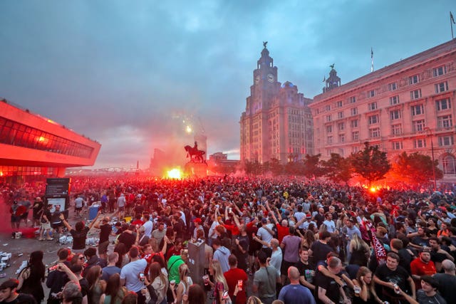 Liverpool fans let off flares outside the Liver Building