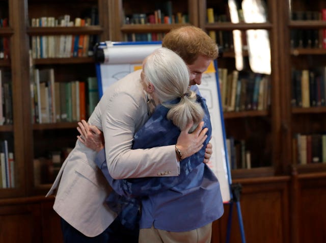 The Duke of Sussex pictured hugging Dr Jane Goodall at a recent event, has interviewed the chimpanzee expert for British Vouge. Kirsty Wigglesworth/PA Wire