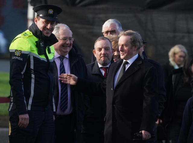 Enda Kenny (right) arrives for the funeral in Dunboyne