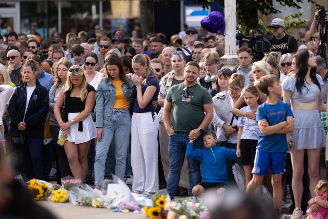 Members of the public taking part in a vigil