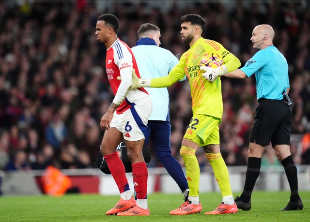 Gabriel is helped off the pitch by his Arsenal team-mates