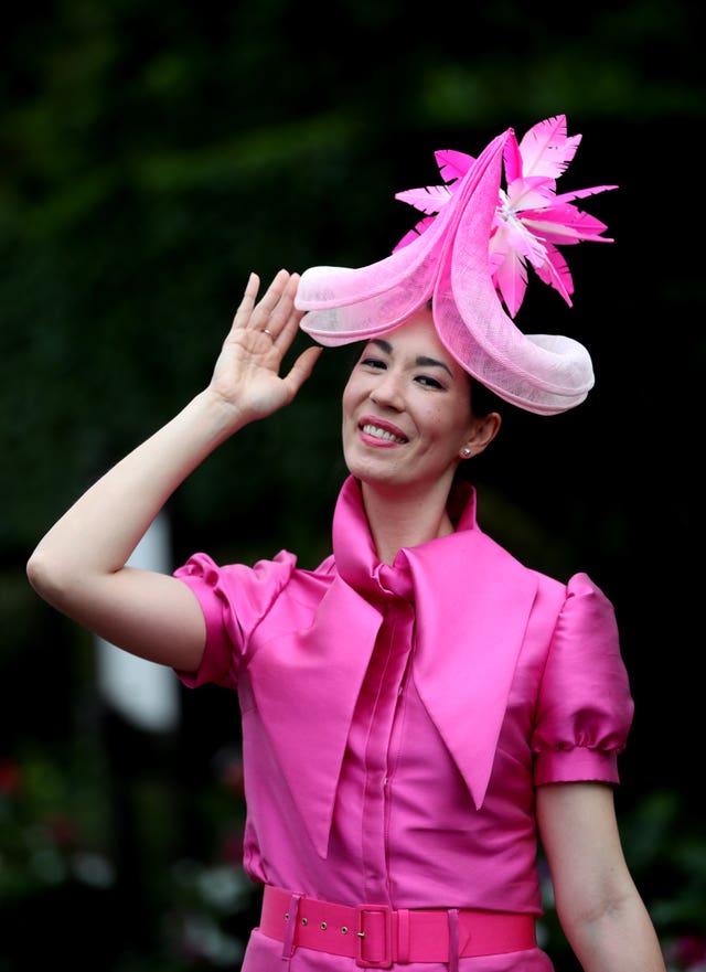 A racegoer poses for a photo on arrival ahead of day three of Royal Ascot at Ascot Racecourse