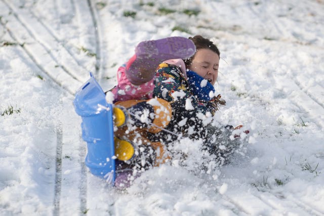 Child plays in snow