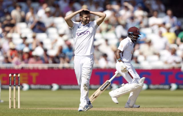 Mark Wood puts his hands on his head