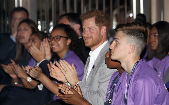 Harry claps as he sits with young people at Diana Award event in 2019