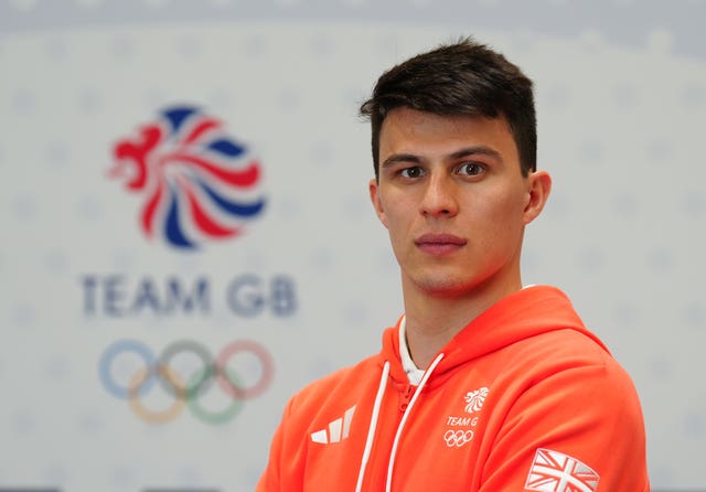 Joe Choong in front of a Team GB logo. 