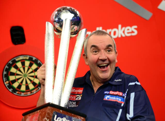 Phil Taylor holds the World Championship trophy