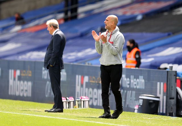 Manchester City manager Pep Guardiola, right, watches on 