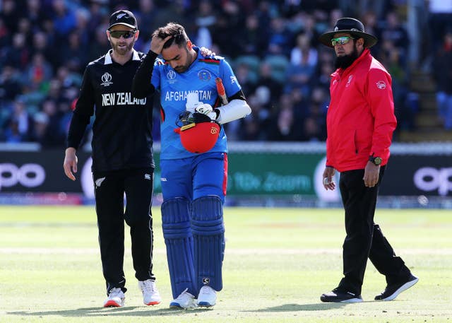 Rashid Khan, centre, took a blow on the helmet and did not bowl in New Zealand's innings (Mark Kerton/PA)