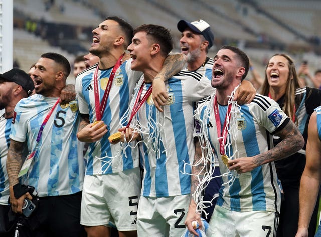 Argentina’s Leandro Paredes, second left, Rodrigo De Paul, right, and Paulo Dybala, centre, celebrate winning the World Cup 