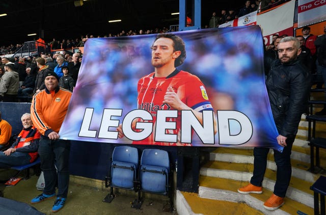 Luton fans hold up a banner of support for Tom Lockyer