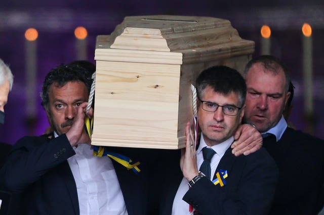 The coffin is carried from the church